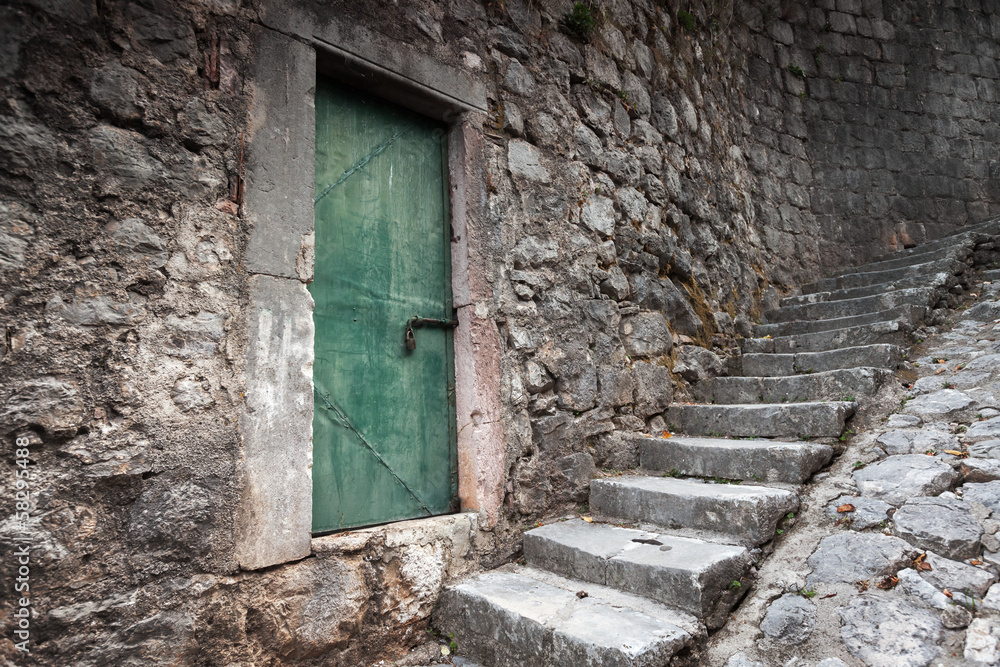 Old locked green door and stone stairway in Perast town, Montene Old locked green door and stone stairway in Perast town, Montene