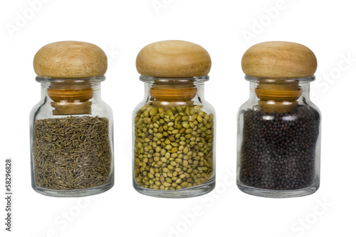 Three containers of assorted spices