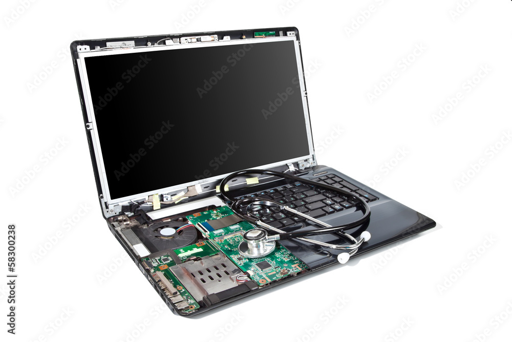 Laptop half disassembled with stethoscope on it Laptop half disassembled with stethoscope on it