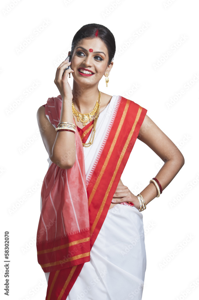 Traditional Bengali woman talking on cell phone Traditional Bengali woman talking on cell phone