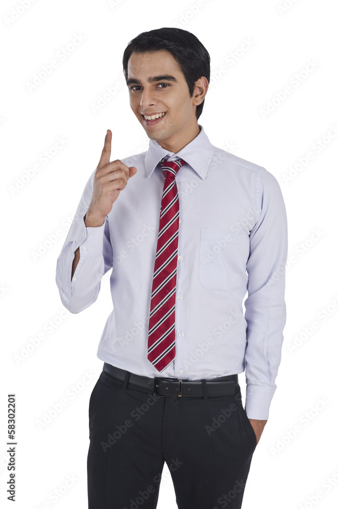 Portrait of a businessman pointing and smiling Portrait of a businessman pointing and smiling
