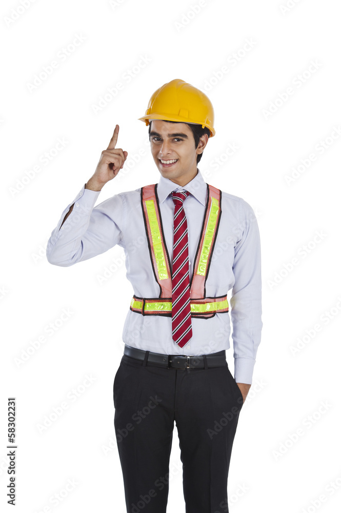 Male architect pointing and smiling Male architect pointing and smiling