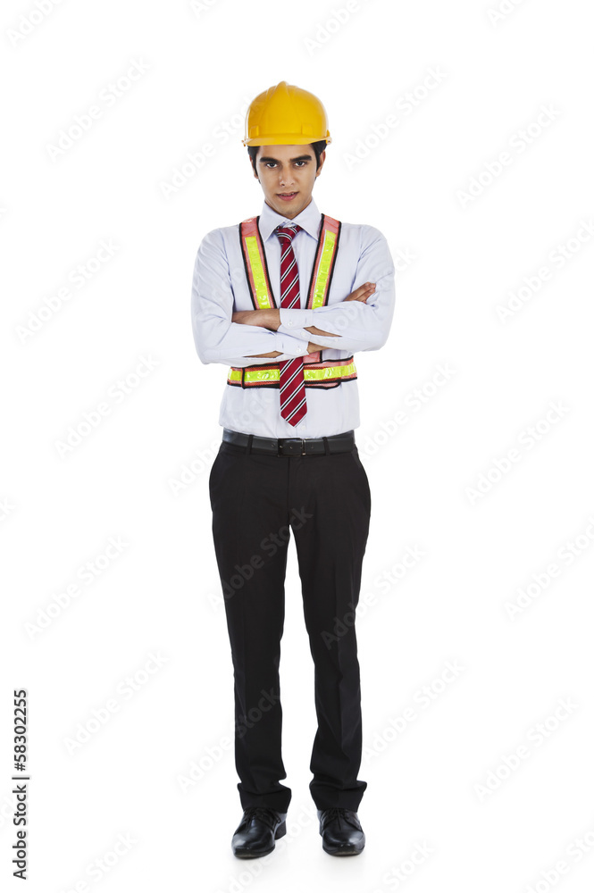 Male architect standing with his arms crossed Male architect standing with his arms crossed