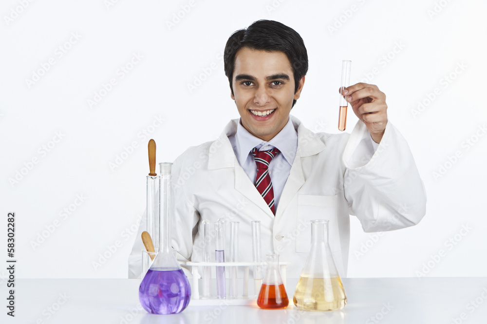Male scientist working in a laboratory and smiling Male scientist working in a laboratory and smiling