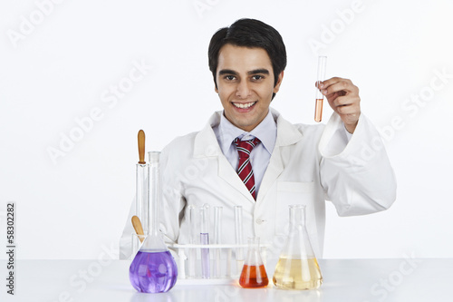 Male scientist working in a laboratory and smiling