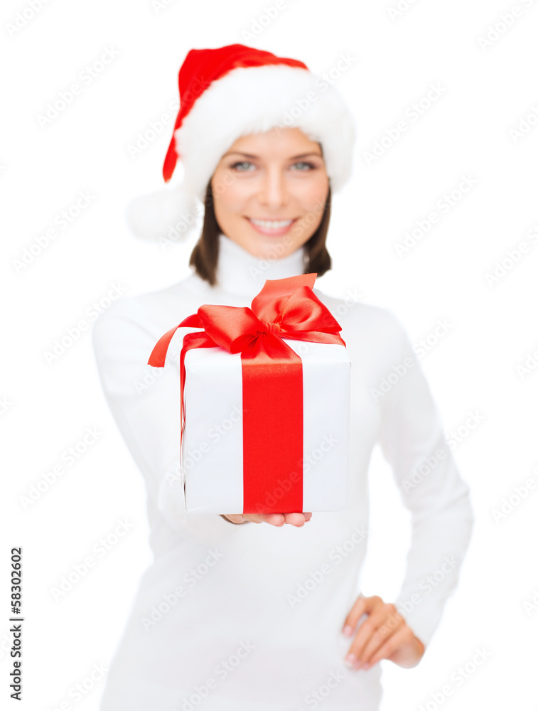 woman in santa helper hat holding gift box woman in santa helper hat holding gift box