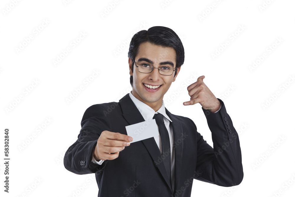 Businessman showing a blank business card and gesturing call me Businessman showing a blank business card and gesturing call me