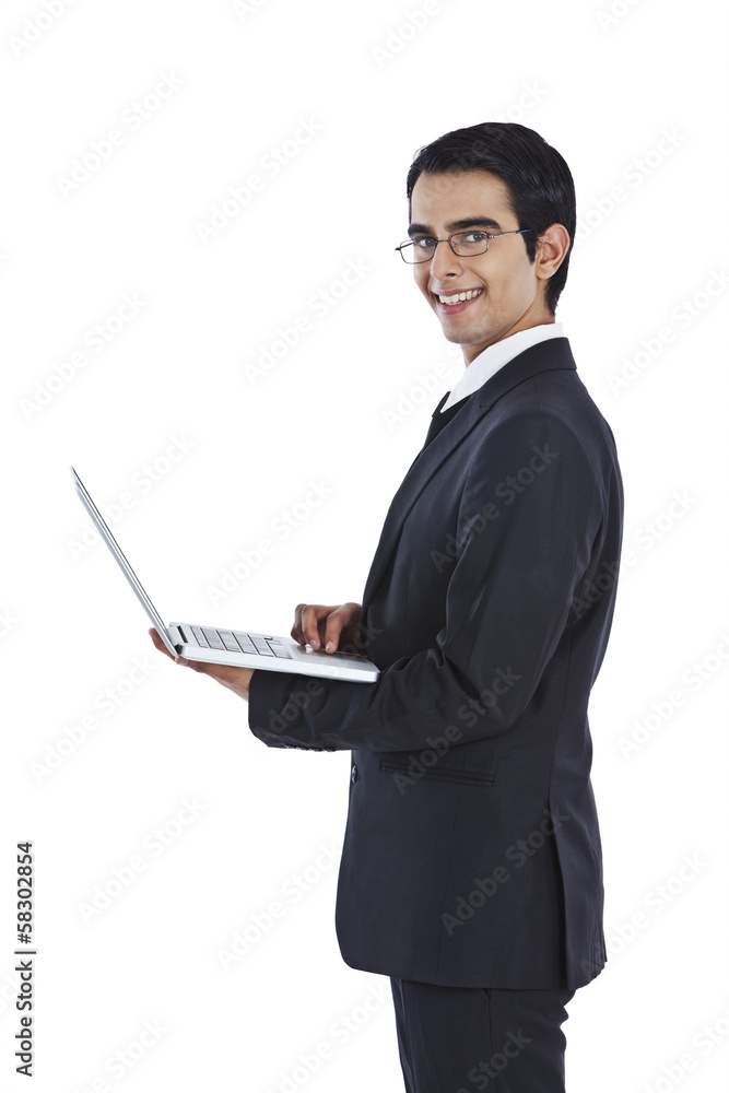 Portrait of a businessman using a laptop and smiling Portrait of a businessman using a laptop and smiling