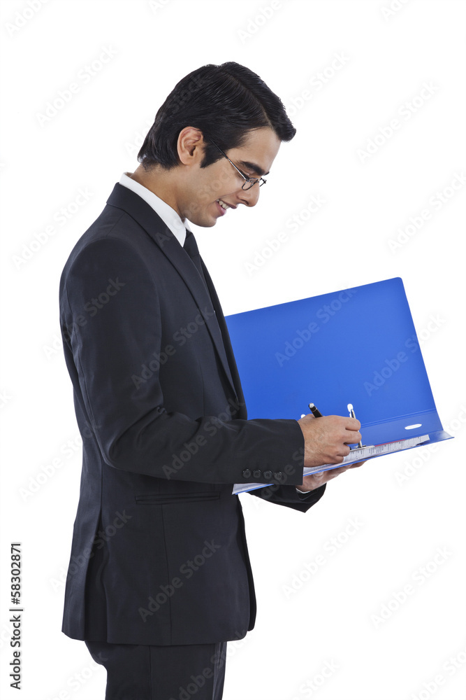 Businessman examining documents and smiling