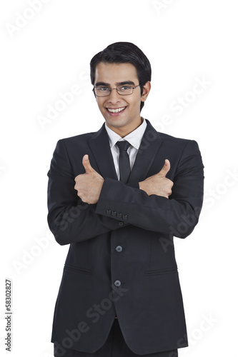 Portrait of a businessman showing thumbs up