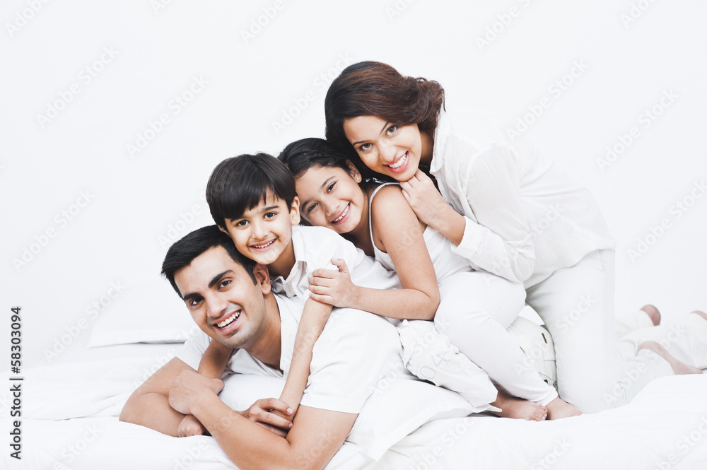 Portrait of a happy family on the bed