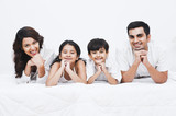 Portrait of a happy family smiling on the bed