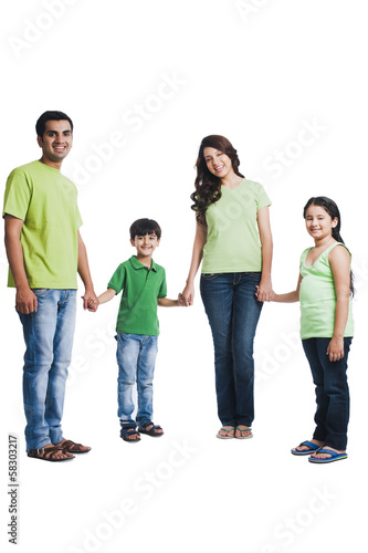 Portrait of a happy family holding hands