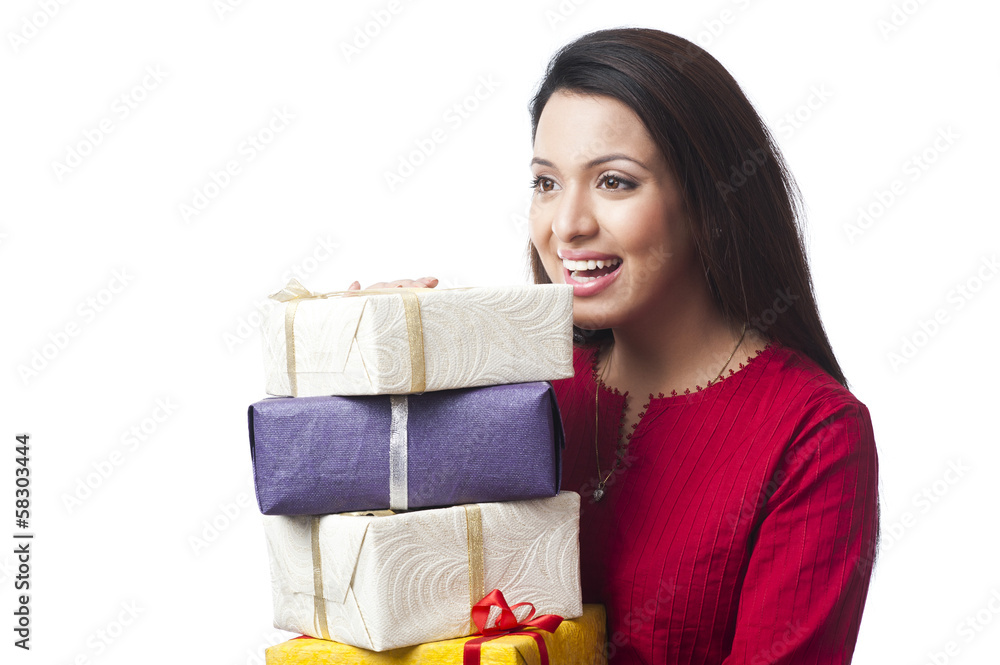 Close-up of a happy woman holding a stack of gifts Close-up of a happy woman holding a stack of gifts