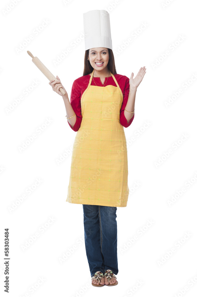 Portrait of a happy woman holding a rolling pin Portrait of a happy woman holding a rolling pin