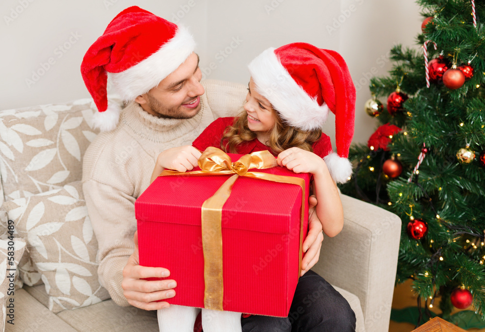 smiling father and daughter opening gift box