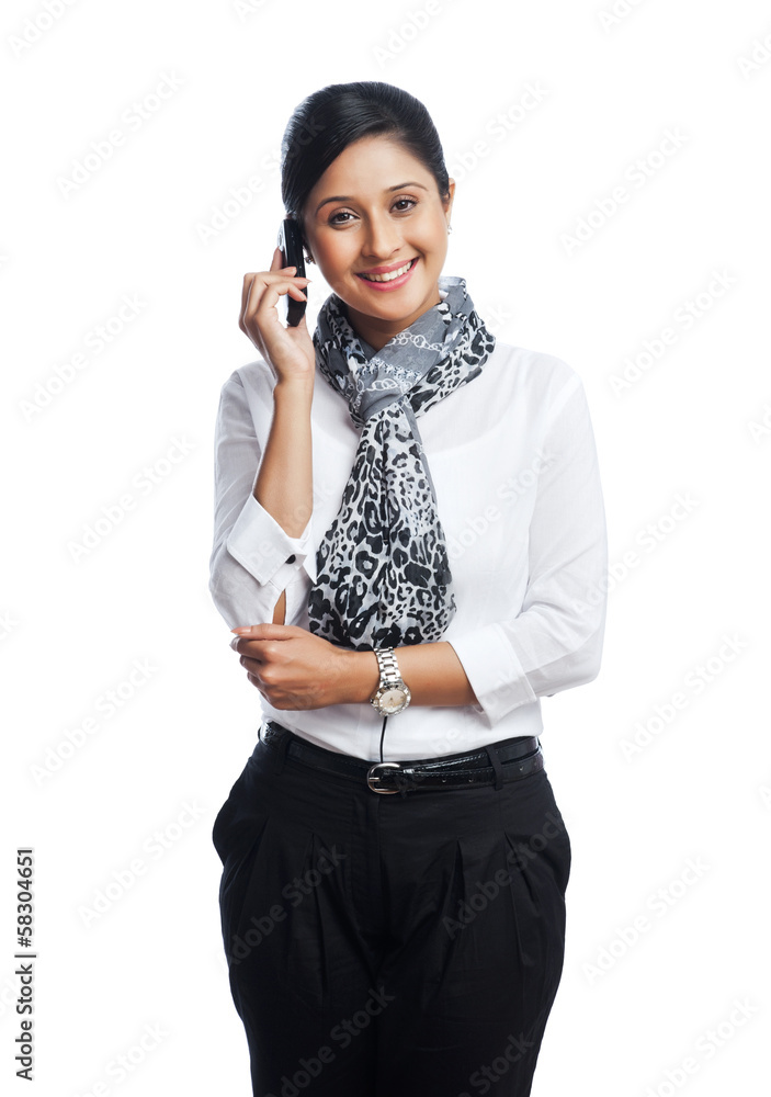 Portrait of a businesswoman talking on a mobile phone and smiling Portrait of a businesswoman talking on a mobile phone and smiling