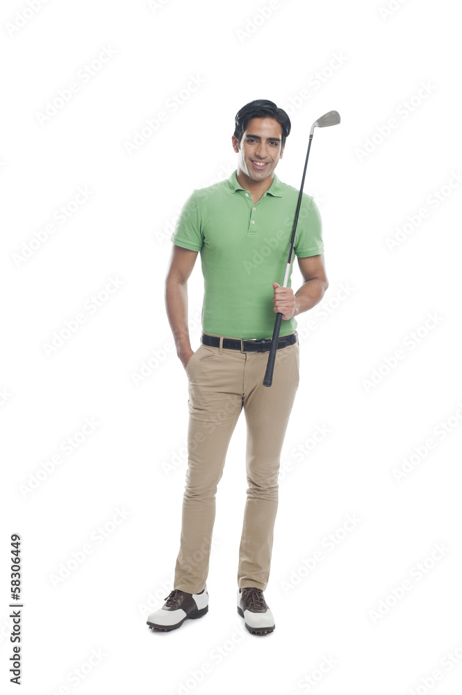 Male golfer holding a golf club and smiling Male golfer holding a golf club and smiling