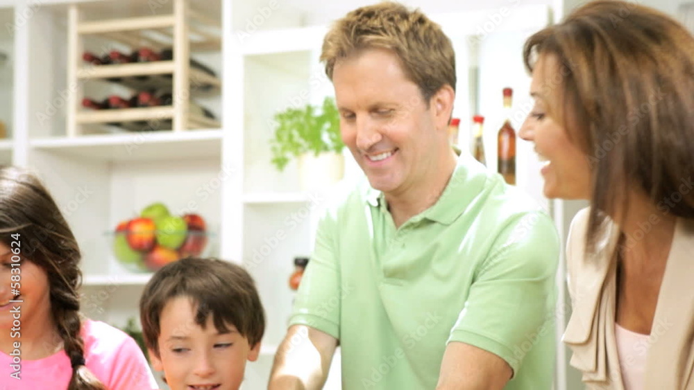 Caucasian Family Preparing Lunch Using Fresh Salad Vegetables Caucasian Family Preparing Lunch Using Fresh Salad Vegetables