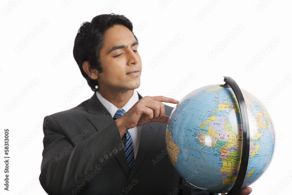 Businessman looking at a globe Businessman looking at a globe