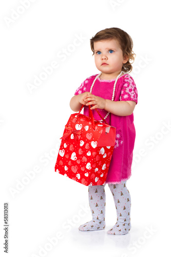 little kid with red paper bag