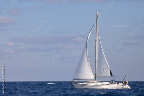 Sailing boat in blue sea