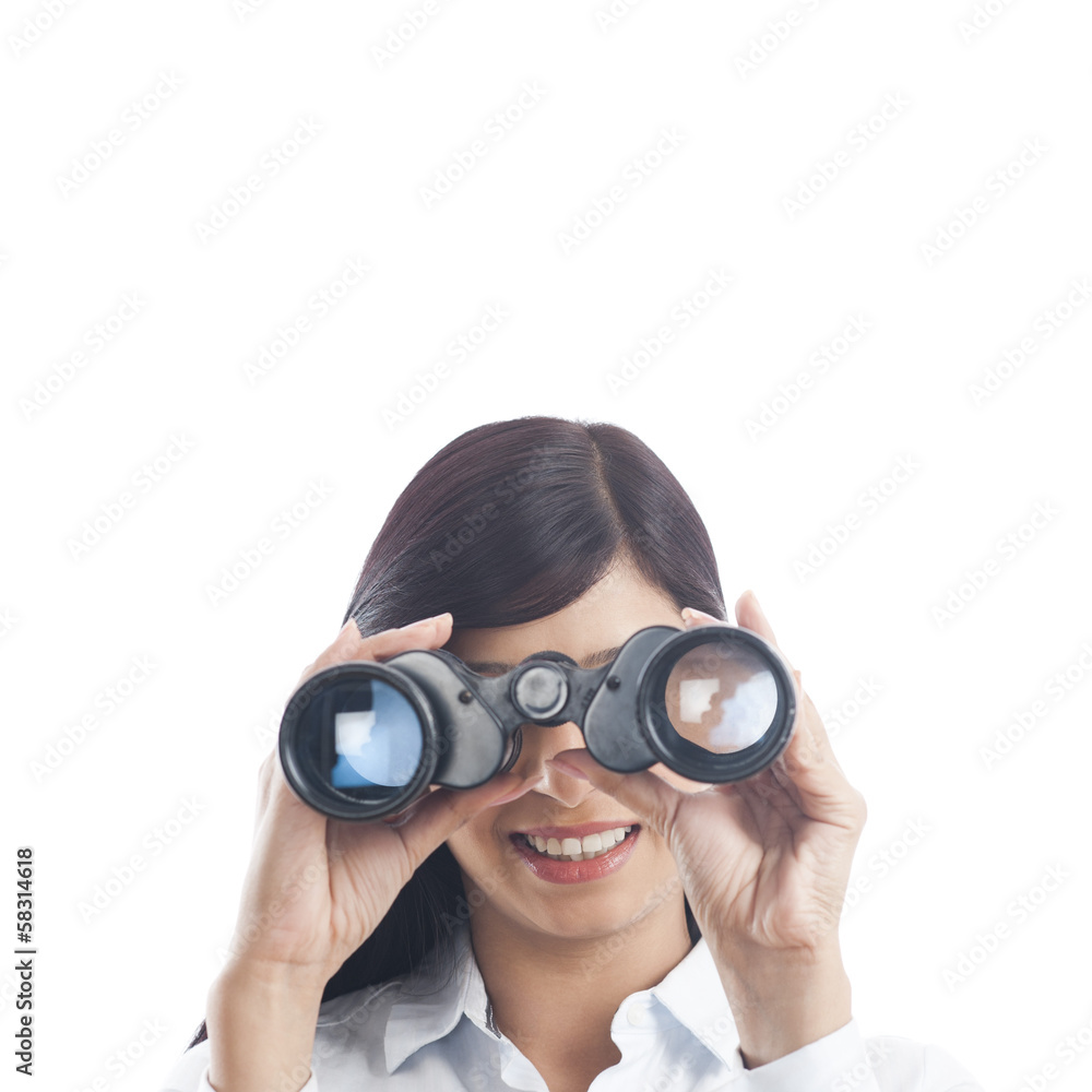 Businesswoman looking through binoculars Businesswoman looking through binoculars