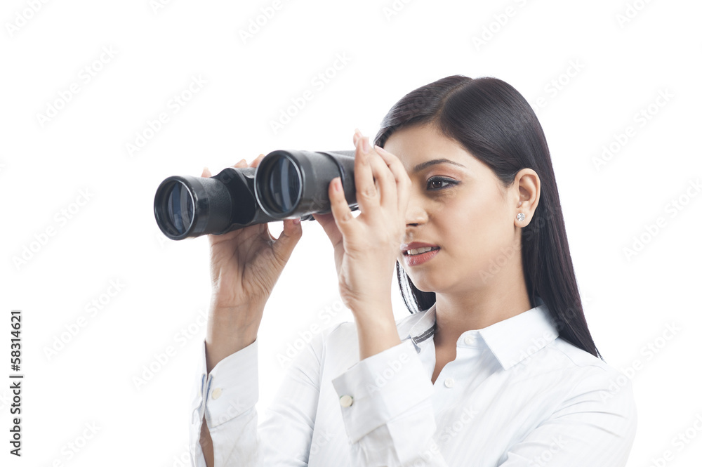Businesswoman looking through binoculars Businesswoman looking through binoculars