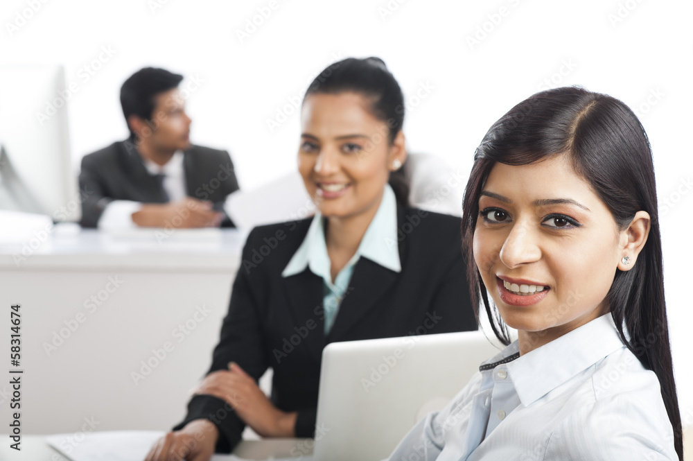 Portrait of two businesswomen smiling in an office Portrait of two businesswomen smiling in an office