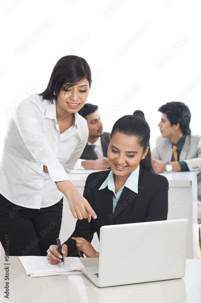 Businesswomen working in the office with their colleagues in Businesswomen working in the office with their colleagues in