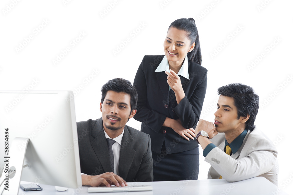 Business executives working on a desktop pc Business executives working on a desktop pc