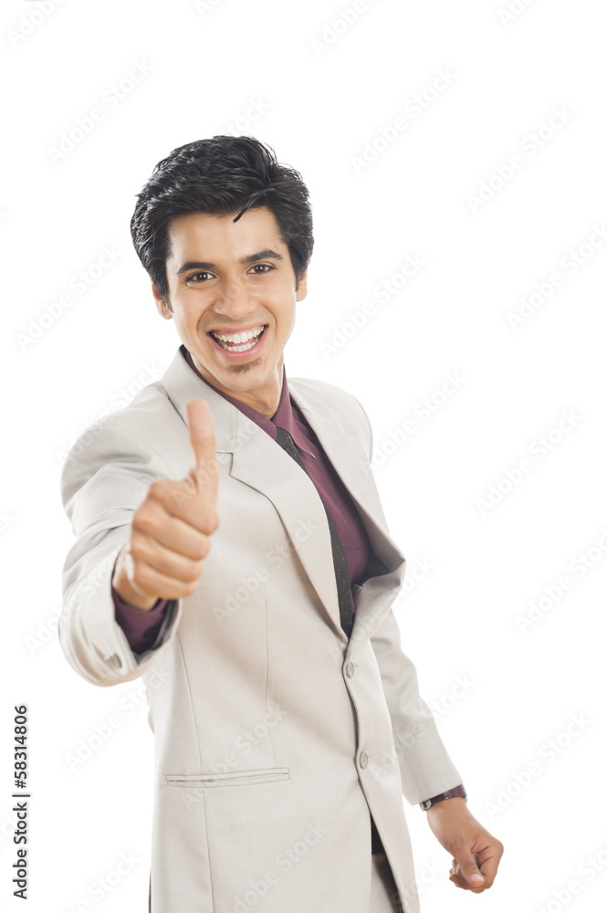 Portrait of a businessman showing thumbs up sign and smiling Portrait of a businessman showing thumbs up sign and smiling
