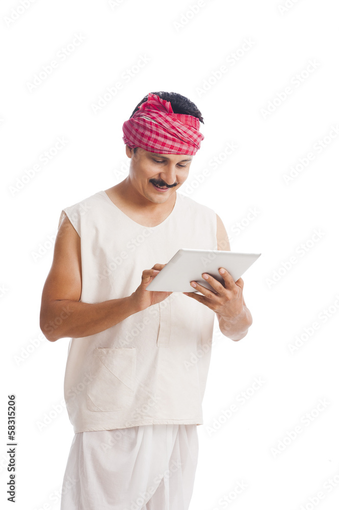 Farmer using a digital tablet and smiling Farmer using a digital tablet and smiling