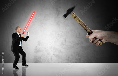 Businessman fighting  with a laser-sword - business challenge photo