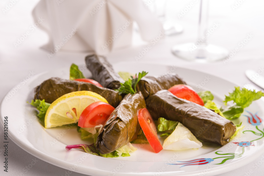 Turkish Style Dolmas Arranged with Tomatoes Lemon and Lettuce