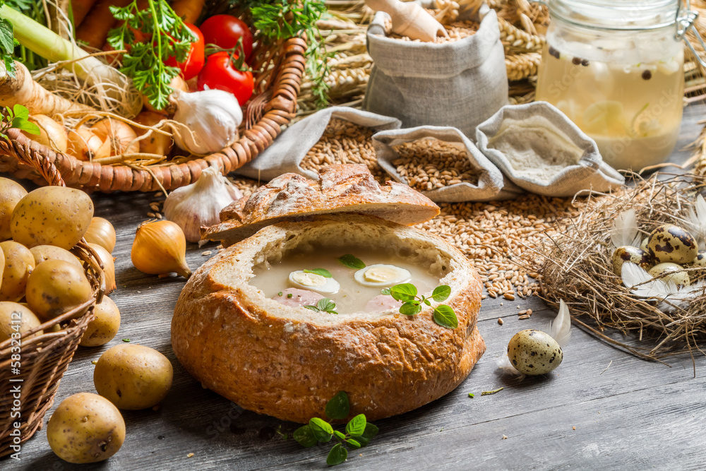 Homemade sour soup in bread with marjoram Homemade sour soup in bread with marjoram