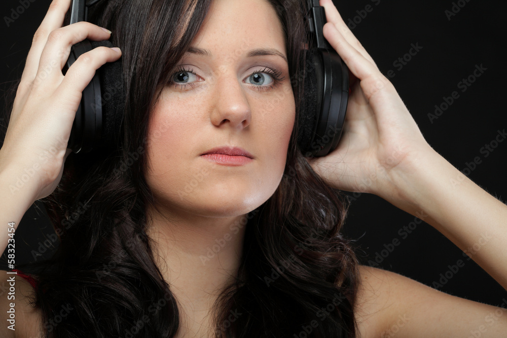 Fototapeta premium young woman listening to music on headset