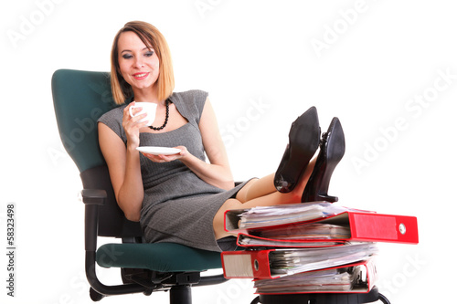 businesswoman relaxing with cup and legs on plenty of document © anetlanda