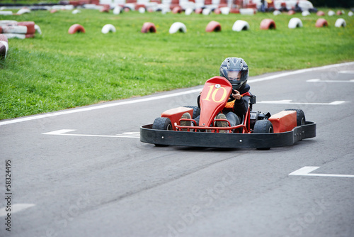 Little karting racer on the track