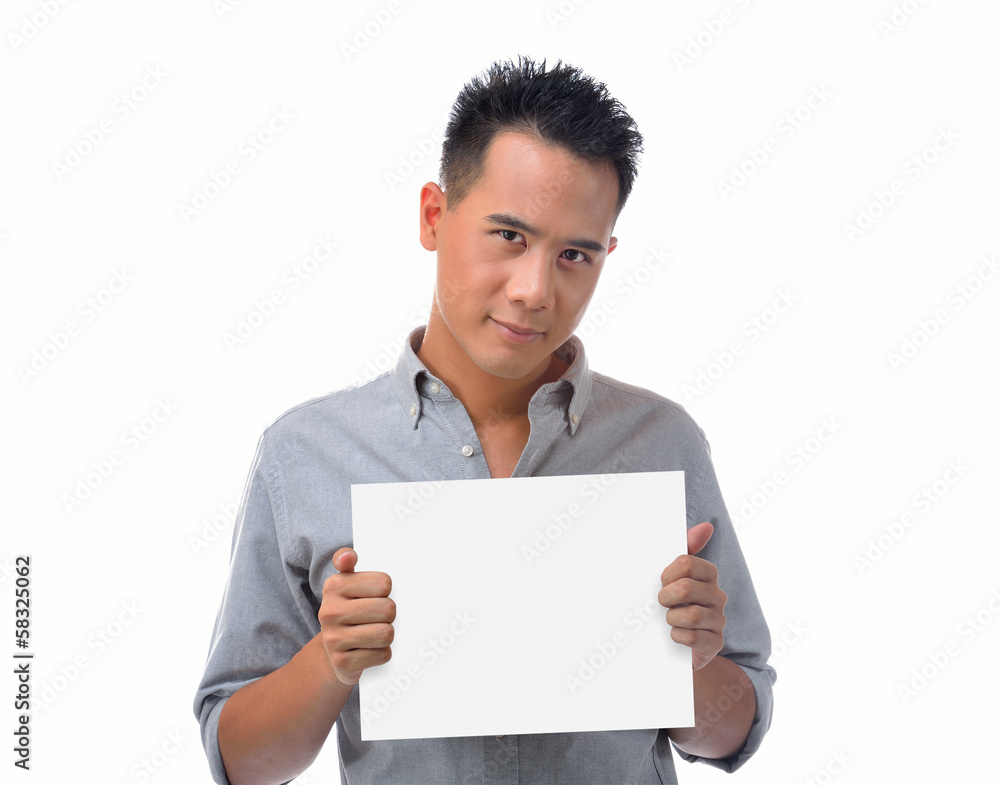 Young man holding blank billboard