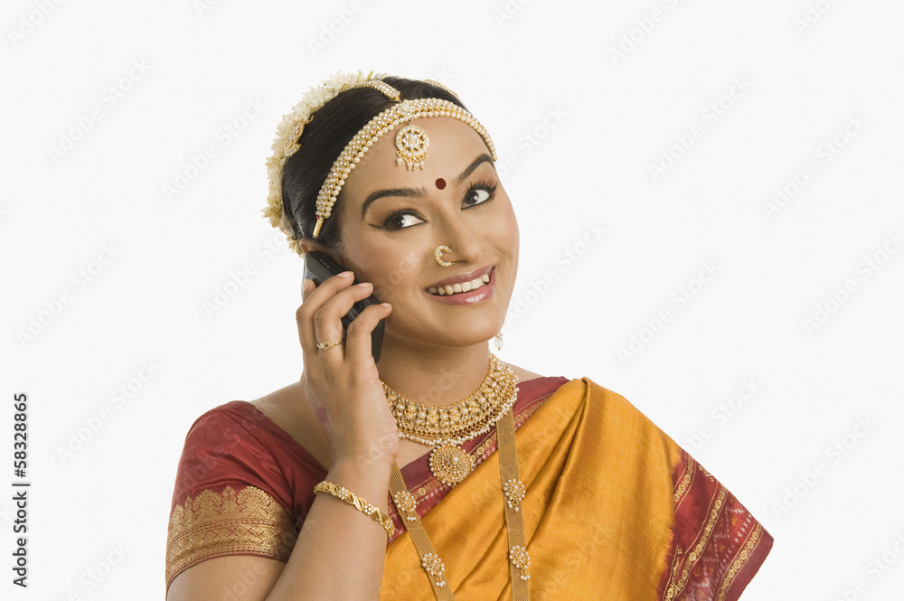 South Indian woman talking on a mobile phone South Indian woman talking on a mobile phone