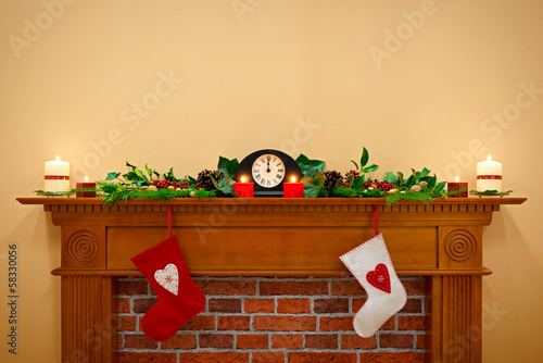 Christmas stockings and garland on a mantlepiece photo