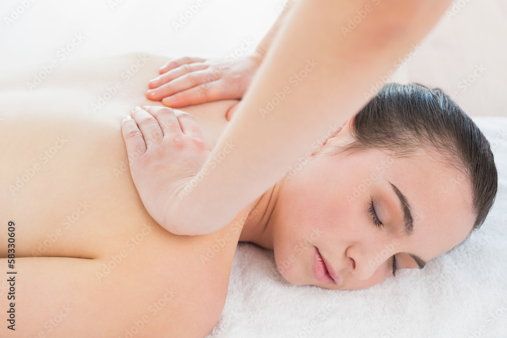 Beautiful woman enjoying back massage at beauty spa