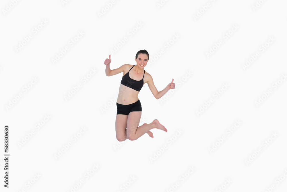 Full length of a sporty young woman jumping