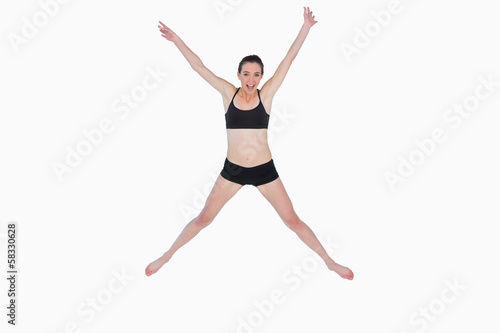 Full length of a sporty young woman jumping