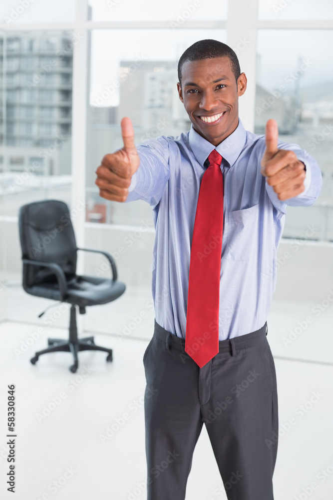 Elegant Afro businessman gesturing thumbs up in office Elegant Afro businessman gesturing thumbs up in office