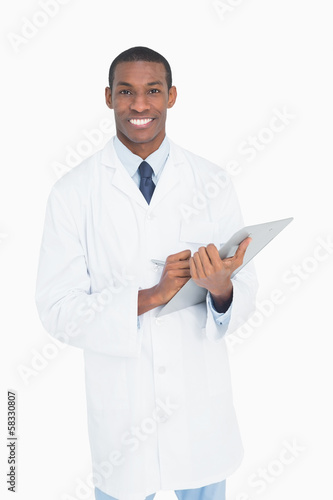 Portrait of a smiling male doctor with clipboard