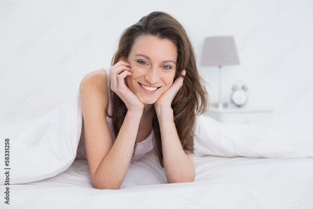 Portrait of a pretty smiling woman resting in bed Portrait of a pretty smiling woman resting in bed