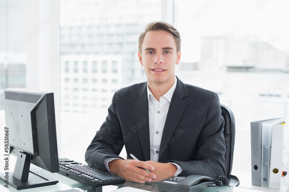 Businessman in front of computer at office desk Businessman in front of computer at office desk