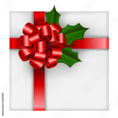 Christmas gift with red bow and holly